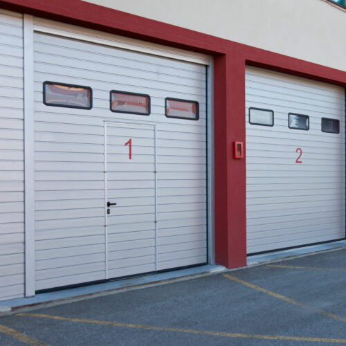 Two large white garage doors numbered 